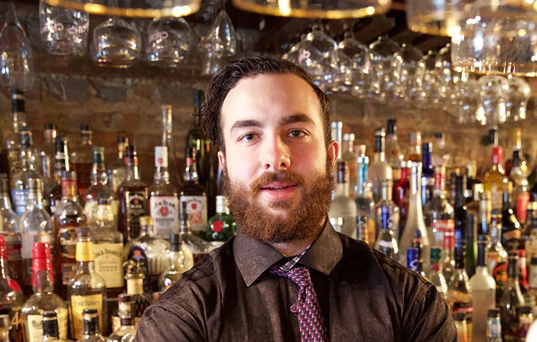 Kevin Girgis behind the bar at Sin & Redemption